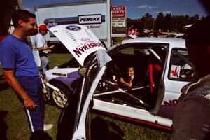 Eric Carlson watches as son Jake sits in the driver's seat of the Carl Merrill / Lance Smith Ford Escort Cosworth RS.