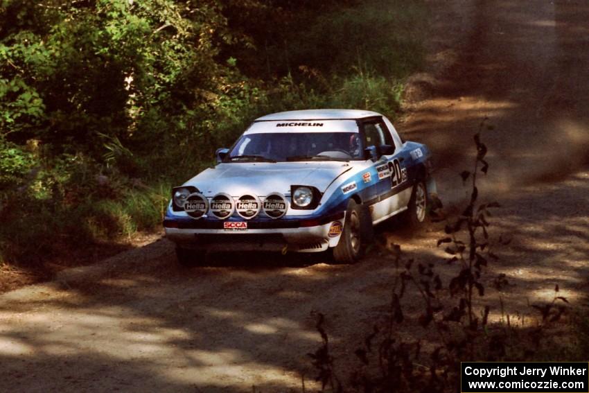 Mike Hurst / Rob Bohn Mazda RX-7 at the spectator point on SS10 (Kabekona).