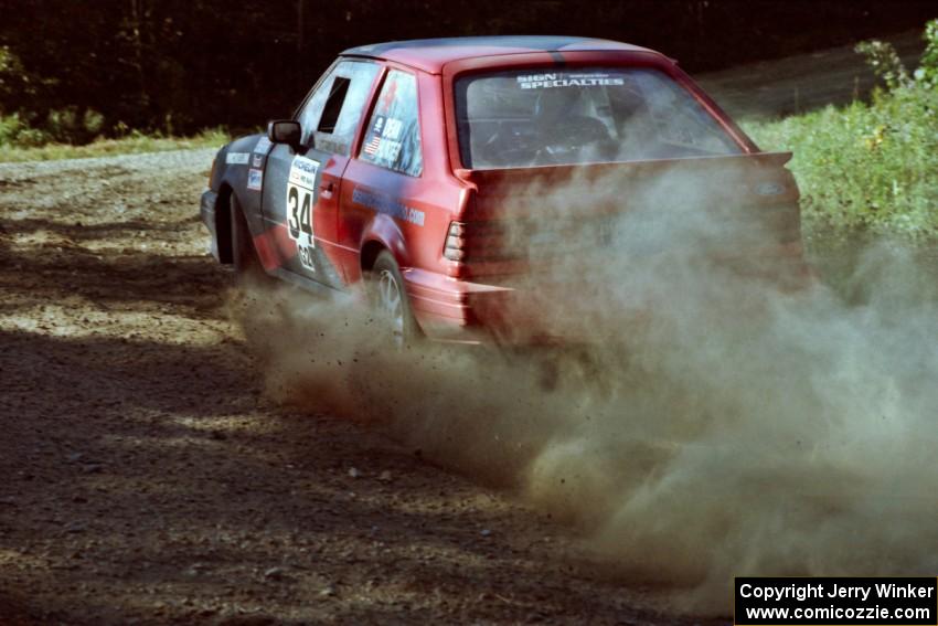 Rod Dean / Nichole Hunter Ford Escort GT at the spectator point on SS10 (Kabekona).