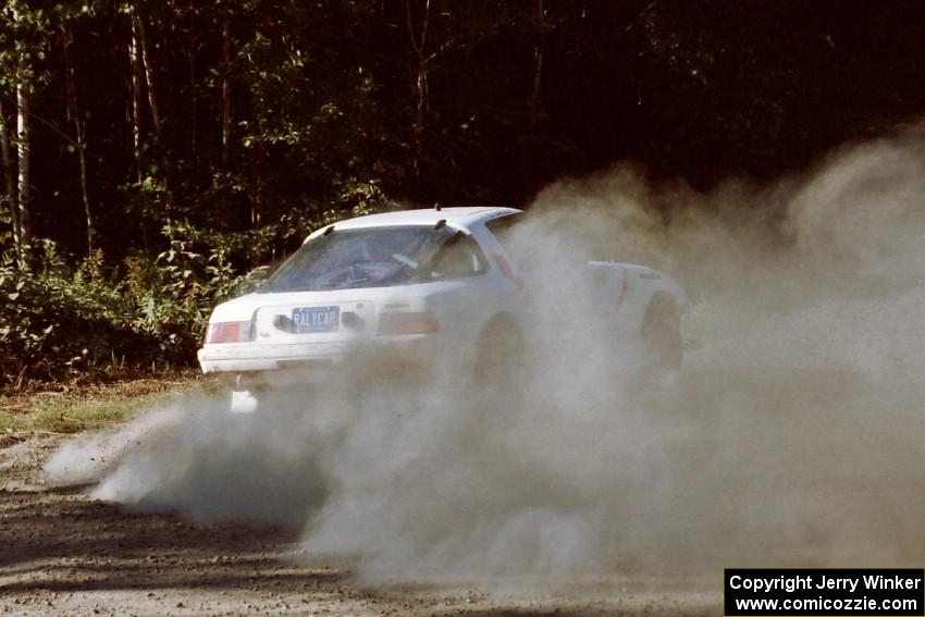 Craig Kazmierczak / Diane Sargent Mazda RX-7 at the spectator point on SS10 (Kabekona).