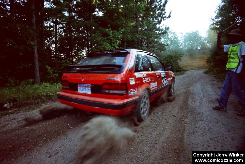 Gail Truess / Pattie Hughes Mazda 323GTX launches from the start of SS13 (Thorpe Tower).