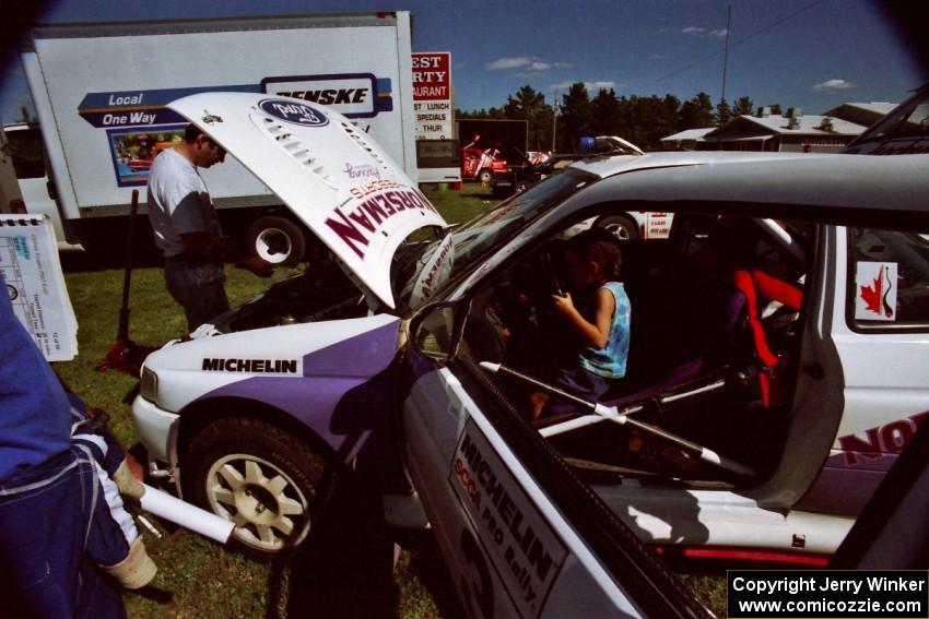 Eric Carlson watches as son Jake sits in the driver's seat of the Carl Merrill / Lance Smith Ford Escort Cosworth RS.