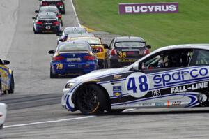 Charles Espenlaub / Charlie Putman BMW M3 Coupe spins as the GS field heads uphill from turn 5 on the first lap.
