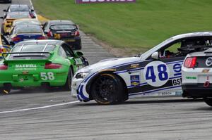 Charles Espenlaub / Charlie Putman BMW M3 Coupe waits as the GS field heads uphill from turn 5 on the first lap.