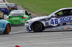 Charles Espenlaub / Charlie Putman BMW M3 Coupe waits as the GS field heads uphill from turn 5 on the first lap.