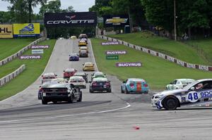 Charles Espenlaub / Charlie Putman BMW M3 Coupe waits as the GS field heads uphill from turn 5 on the first lap.