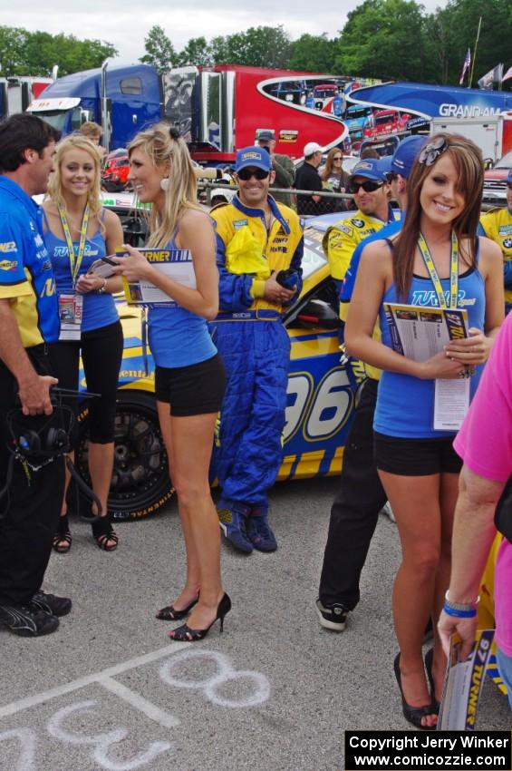 Paul Dalla Lana and Bill Auberlen lean on their BMW M3 Coupe and are surrounded by babes.