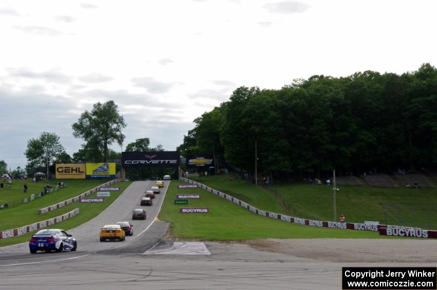 The field heads uphill from turn 5 on the pace lap.