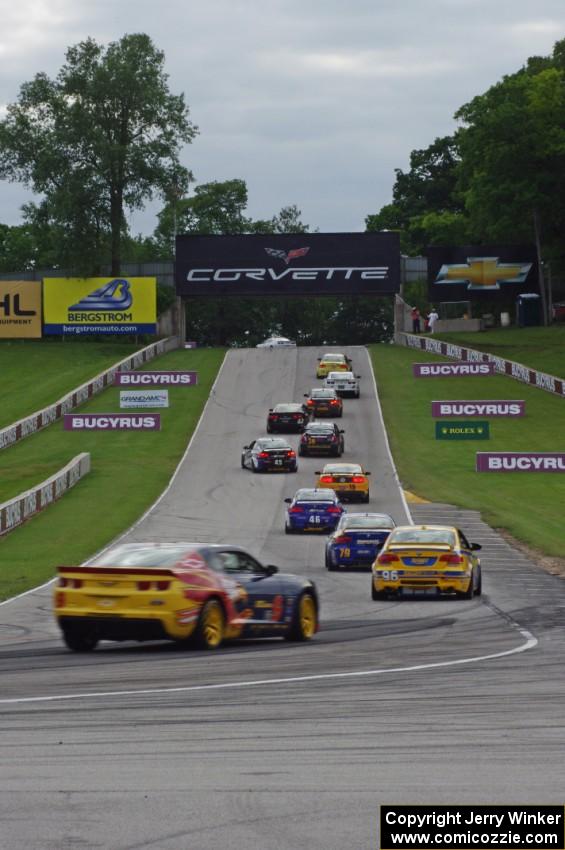 The field heads uphill from turn 5 on the pace lap.
