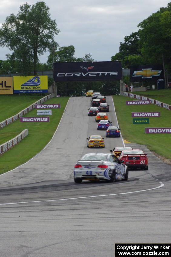 The field heads uphill from turn 5 on the pace lap.