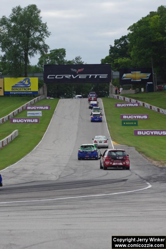 The field heads uphill from turn 5 on the pace lap.