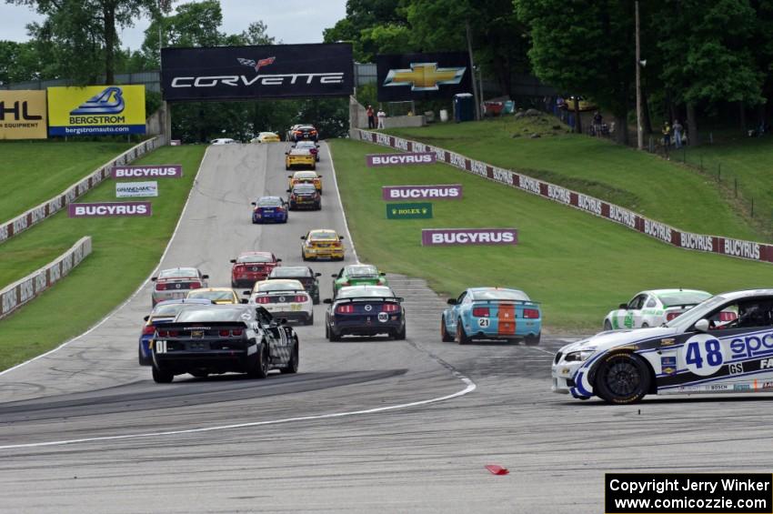 Charles Espenlaub / Charlie Putman BMW M3 Coupe waits as the GS field heads uphill from turn 5 on the first lap.