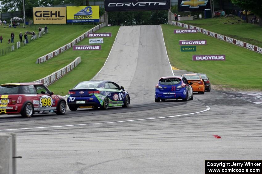 The ST field heads uphill from turn 5 on the first lap.