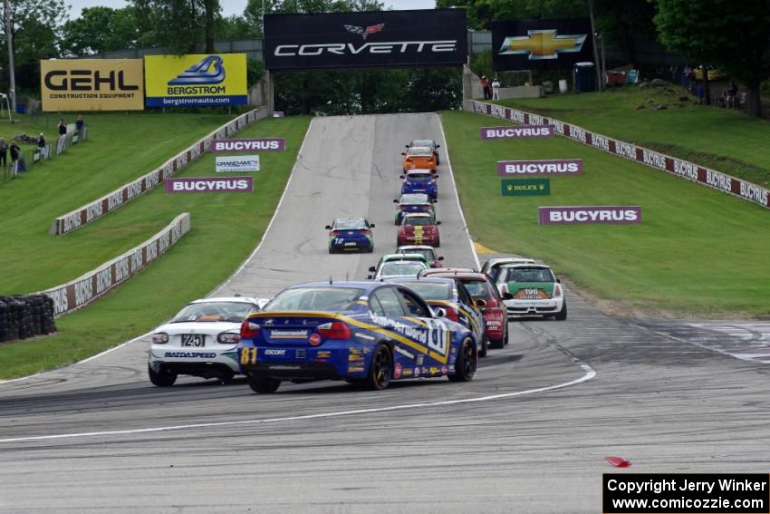 The ST field heads uphill from turn 5 on the first lap.