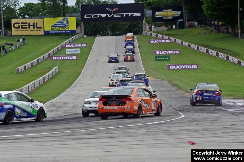 The ST field heads uphill from turn 5 on the first lap.