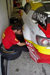 A crew member works on the Joe Nonnamaker / Will Nonnamaker Mazda RX-8.