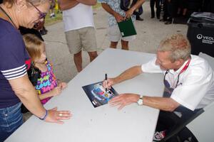 Hurley Haywood signs autographs for fans.