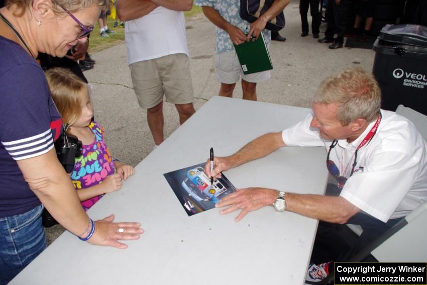 Hurley Haywood signs autographs for fans.