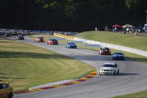 ST cars stream through turns 6 and 7 on one of the pace laps.