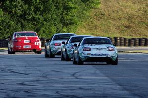 A Honda Civic Si and three Mazda MX-5s at turn 7