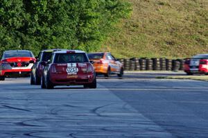 Kyle Gimple / Randall Smalley and Chris Puskar / Dicky Riegel Mini Cooper Ss at the end of a group of ST cars at turn 7