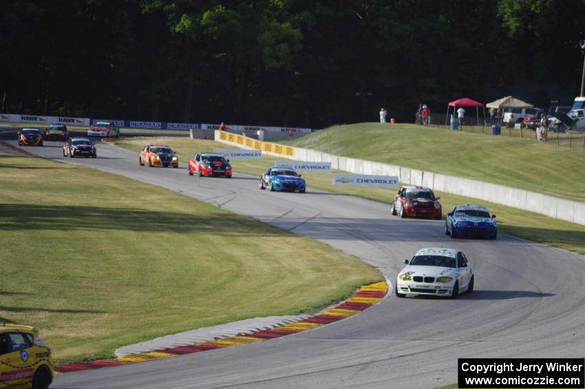 ST cars stream through turns 6 and 7 on one of the pace laps.