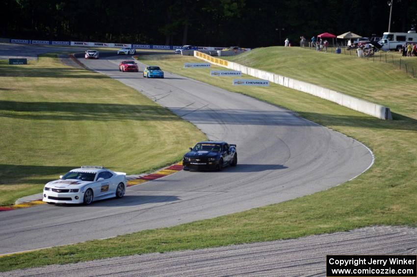 The pace car comes out and slows the field down.