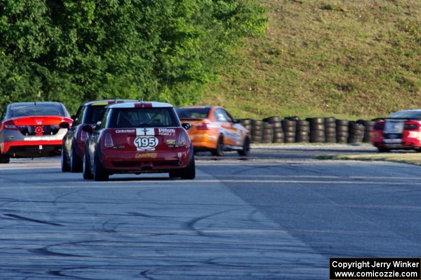 Kyle Gimple / Randall Smalley and Chris Puskar / Dicky Riegel Mini Cooper Ss at the end of a group of ST cars at turn 7