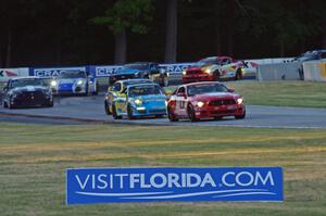 Cars resume racing and come out of turn 6.