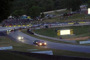 The GS field comes through turn 5 on the cool off lap well after sundown.