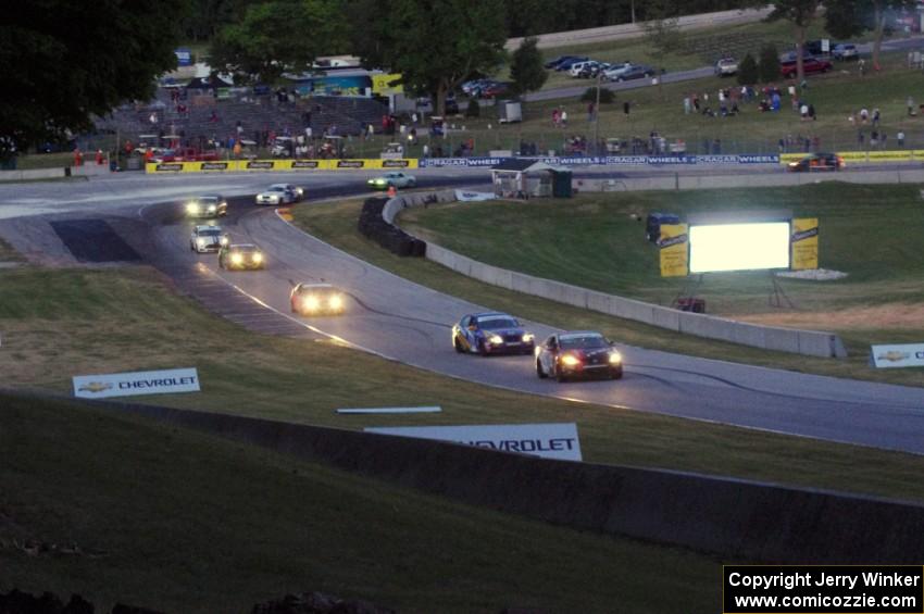 The ST field comes through turn 5 on the cool off lap well after sundown.