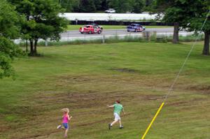 Kids drag race three cars as they dive into turn one