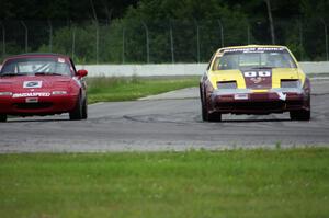 Gopher Broke Racing Nissan 300ZX passes the Penalty Lap Racing Mazda Miata