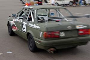 E30 Bombers BMW 325i roars back out of the paddock into the race