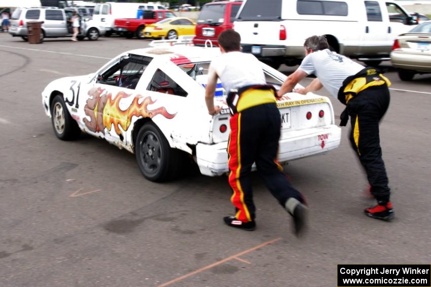 Team Polska Kielbasa Nissan 280ZX gets a push start in the paddock mid-race