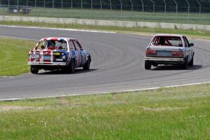 British American Racing BMW 318i passes the North Loop Motorsports 2 BMW 325