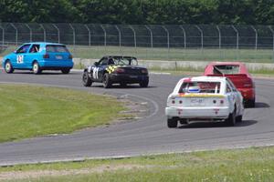 Four cars drive through turn 4