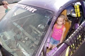 A young fan sits in the My Little Pony Ford Mustang