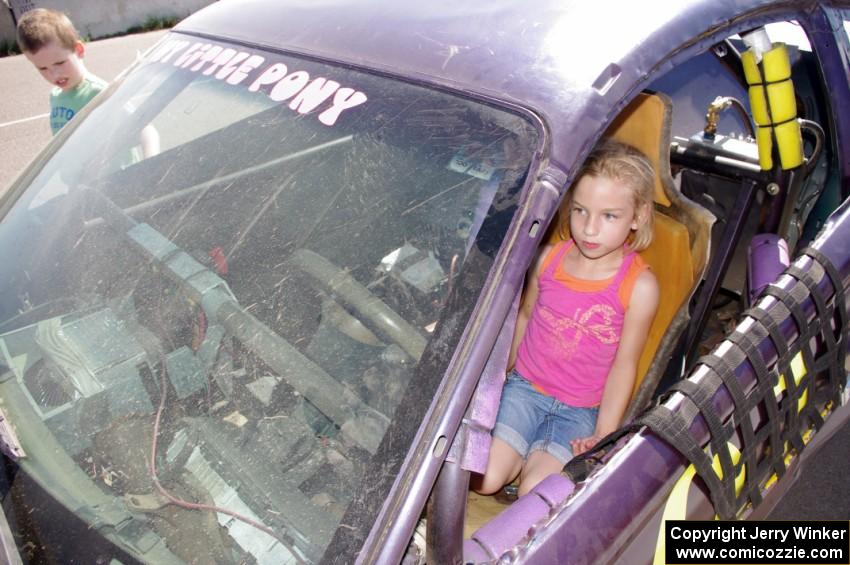 A young fan sits in the My Little Pony Ford Mustang