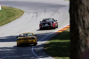 Dan Bender's and Ara Malkhassian's Mazda MX-5s head uphill through turn 13