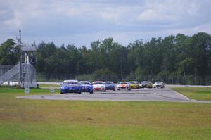 The Mazda MX-5 pack comes into turn 12 on the first lap