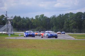 The Mazda MX-5 pack comes into turn 12 on the first lap