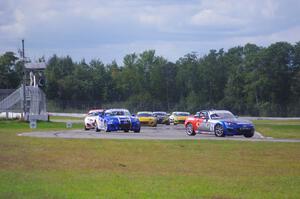 The Mazda MX-5 pack comes into turn 12 on the first lap