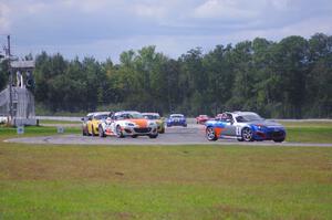 The Mazda MX-5 pack comes into turn 12 on the first lap