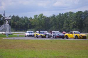 The Mazda MX-5 pack comes into turn 12 on the first lap