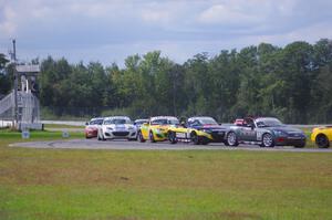 The Mazda MX-5 pack comes into turn 12 on the first lap