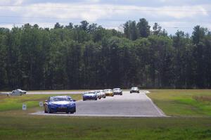 The Mazda MX-5 pack, fronted by Michael Cooper and Jason Saini, comes into turn 4 on lap three.