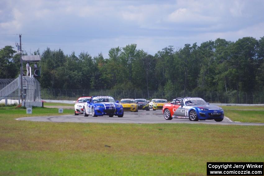 The Mazda MX-5 pack comes into turn 12 on the first lap