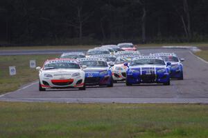 Playboy Mazda MX-5 Cup cars come into turn 4 on the first lap