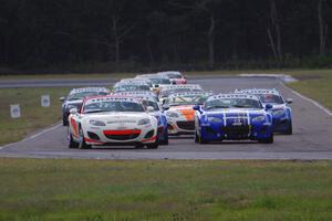 Playboy Mazda MX-5 Cup cars come into turn 4 on the first lap